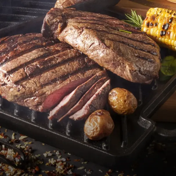 Grilled ribeye steaks in a cast iron pan